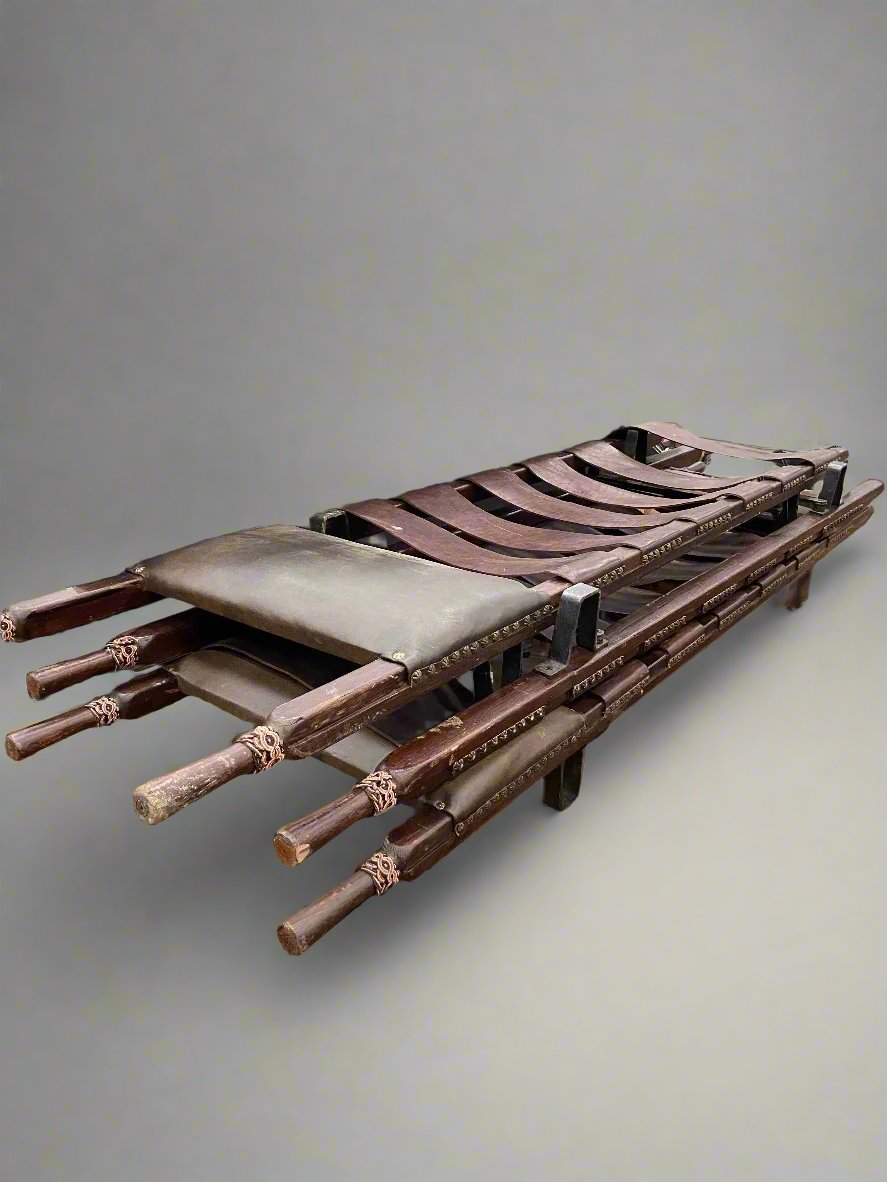 A set of medieval-style leather medical stretchers.