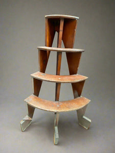 Half-round wooden plant stand with four tiers.