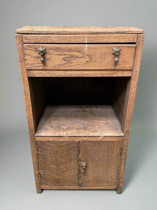 Wooden standing side cabinet with hanging metal handles.