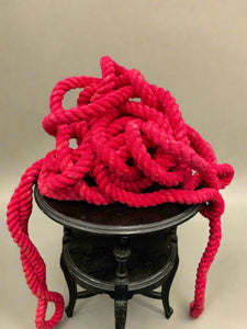 A big bundle of really thick neon pink rope.