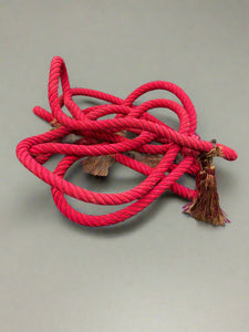 Lengths of thick two-tone pink cord with metallic brassy coloured tassels.