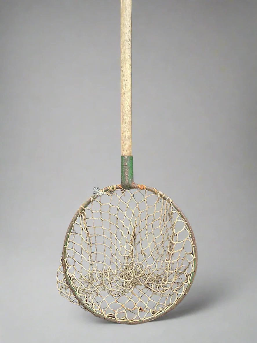 Antique angler's landing net with an open thick rope weave.