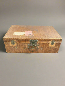 Vintage woven rattan suitcase with pasted labels to the lid. Could be of Chinese origin.