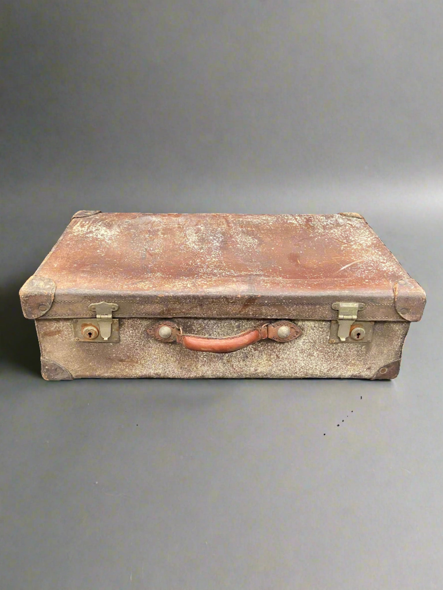 Very aged vintage brown leather suitcase.