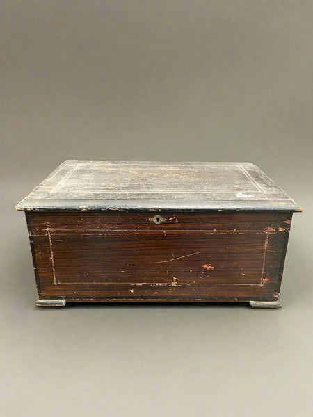 Large antique hand-turned musical box encased in a dark wooden box.&nbsp;