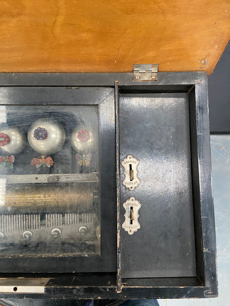 Large antique hand-turned musical box encased in a dark wooden box.&nbsp;