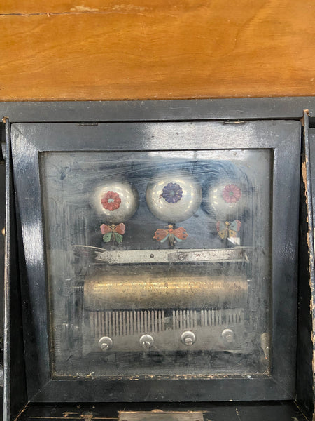 Large antique hand-turned musical box encased in a dark wooden box.&nbsp;