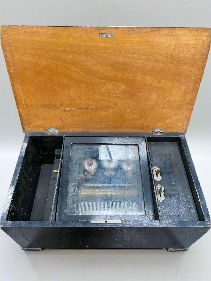 Large antique hand-turned musical box encased in a dark wooden box.&nbsp;