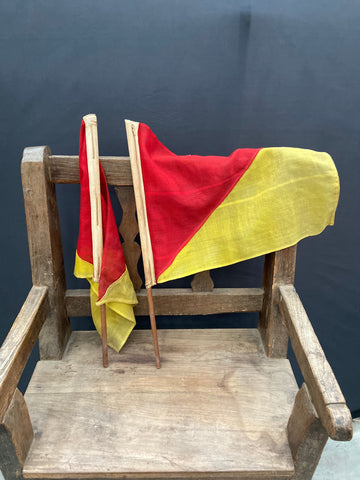 A pair of red and yellow fabric hand flags.