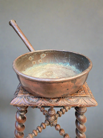 Antique long-handled copper skillet/pan with some verdigris to the inner lining.
