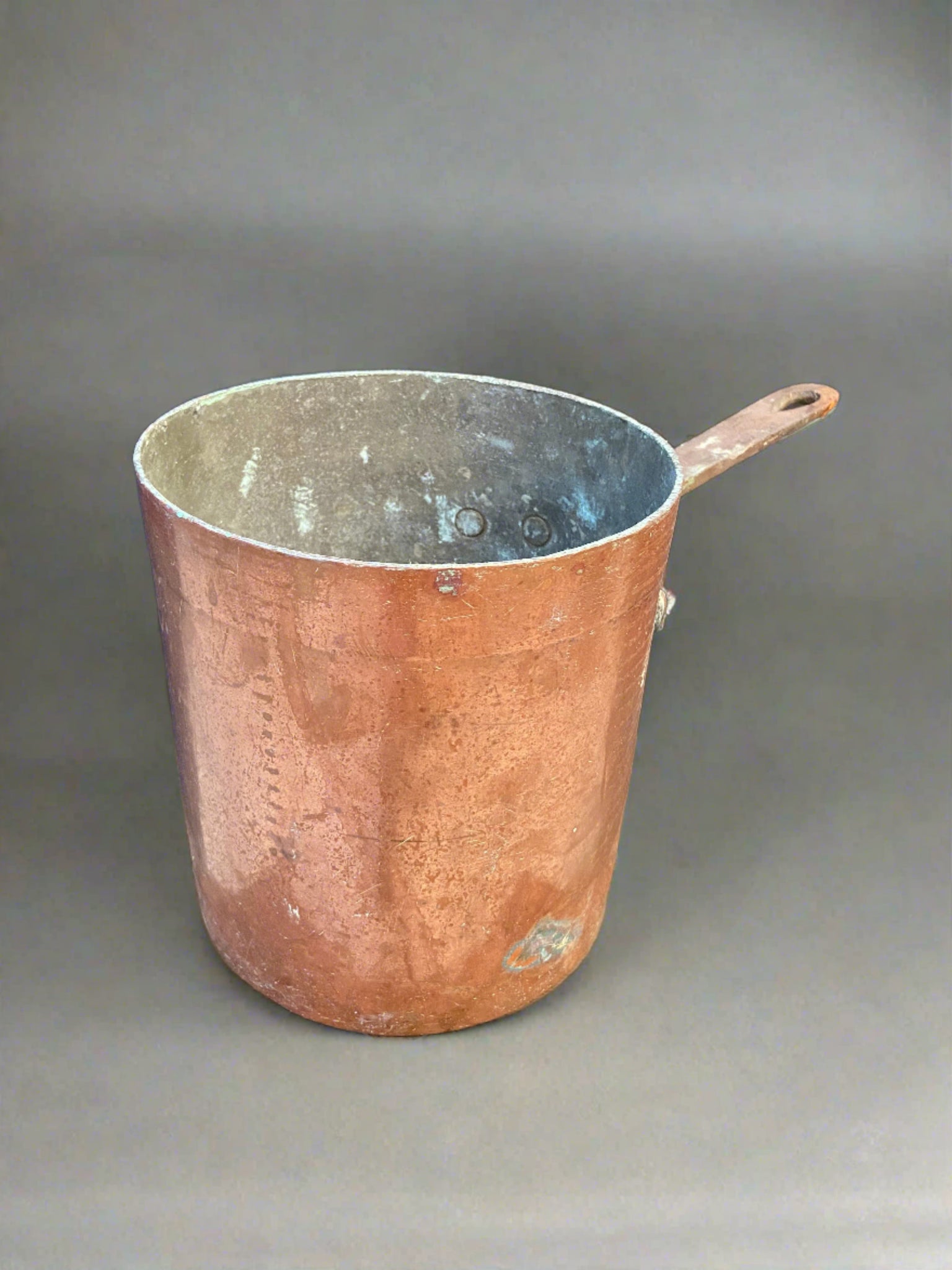 Very deep antique copper saucepan with minor verdigris aging on the inside.