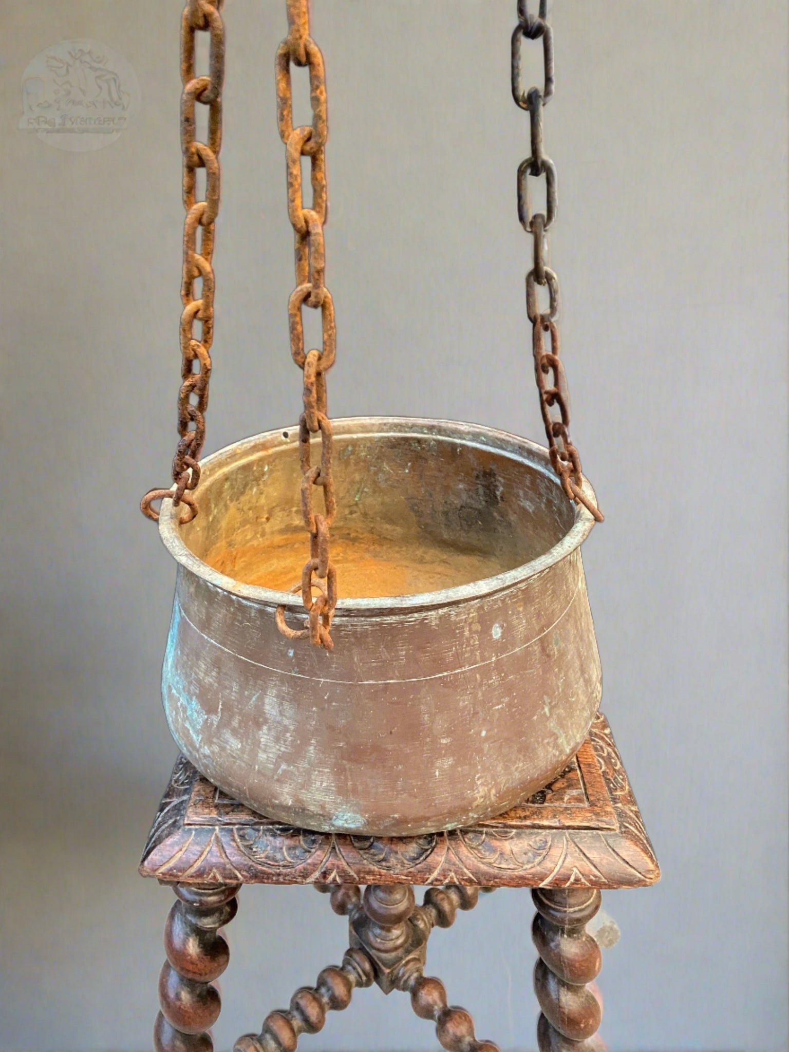 Hanging fireside cooking pot/cauldron on chains.