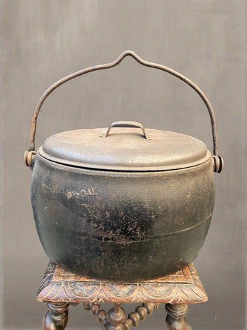 Antique lidded cast iron cooking cauldron pot.