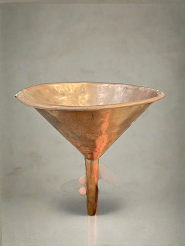 Antique shiny copper funnel.