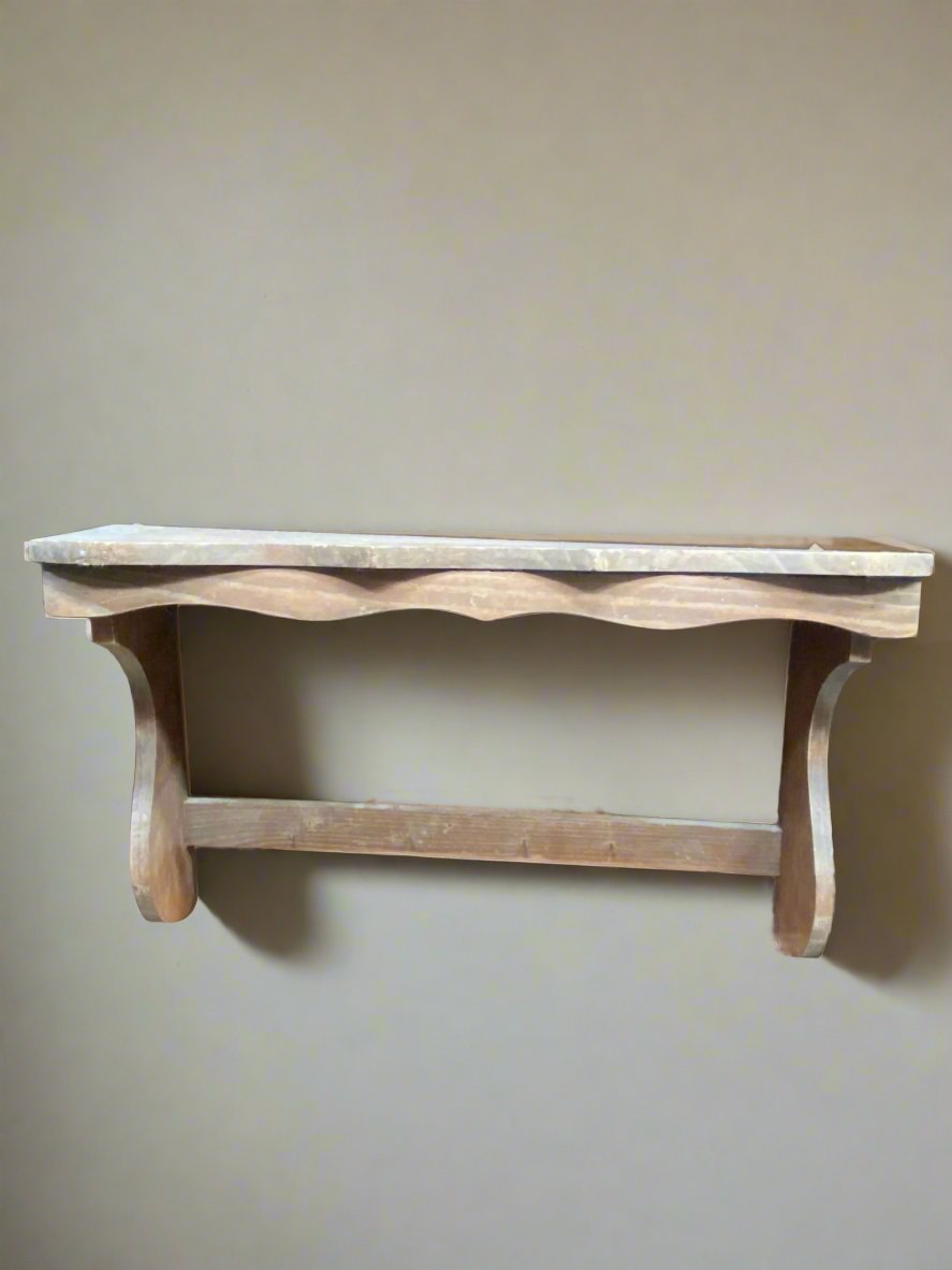 Simple rustic wooden kitchen shelf with curved edging.