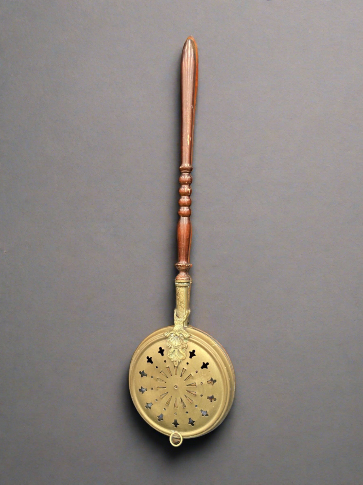 Victorian brass bed warming pan with a decorative lid and varnished turned handle.