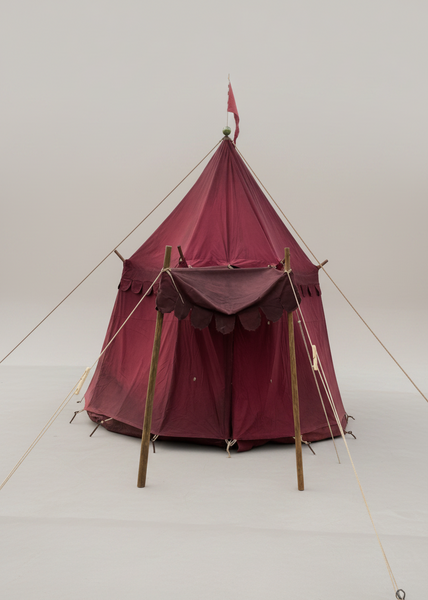 Medieval burgundy jousting tent with a matching flagpole and canopy entrance.