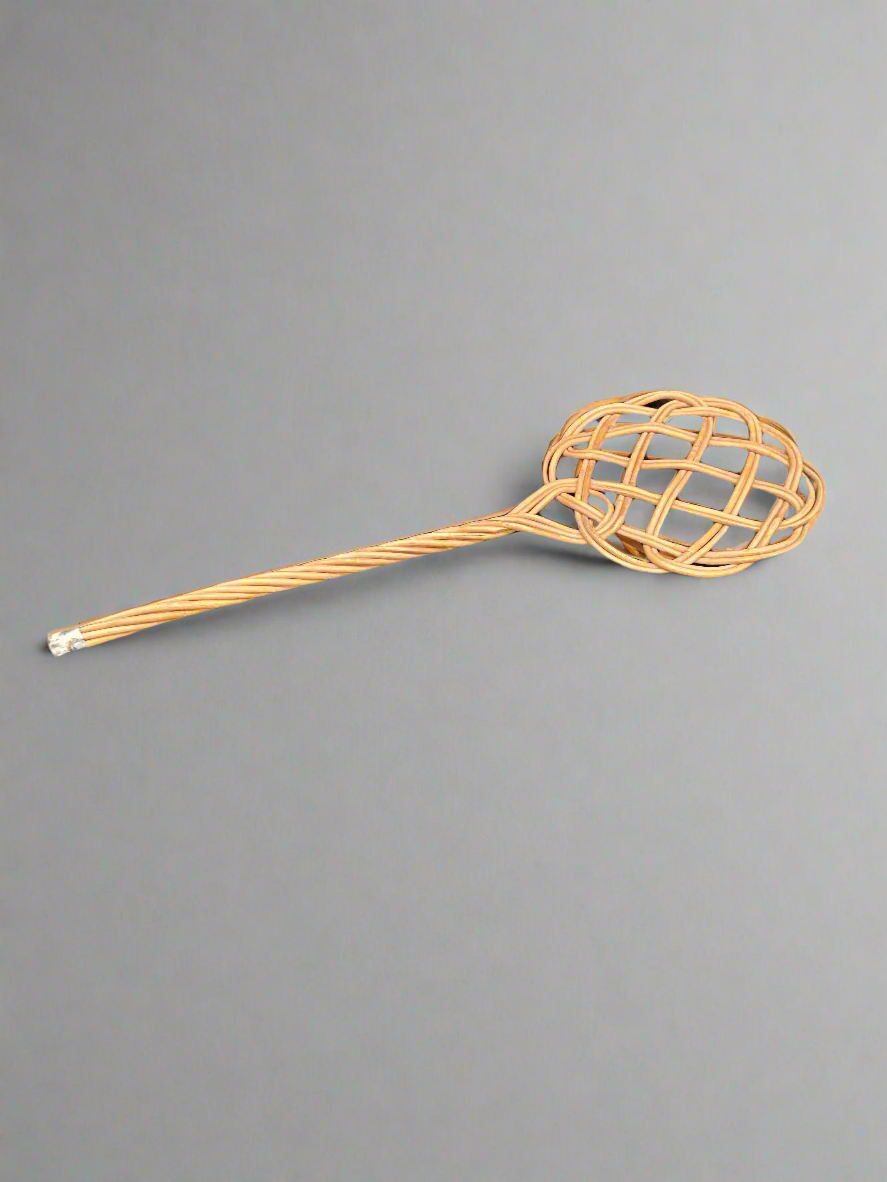 A rustic woven reed/rattan carpet beater.