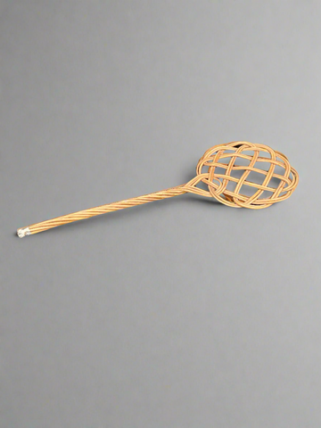 A rustic woven reed/rattan carpet beater.