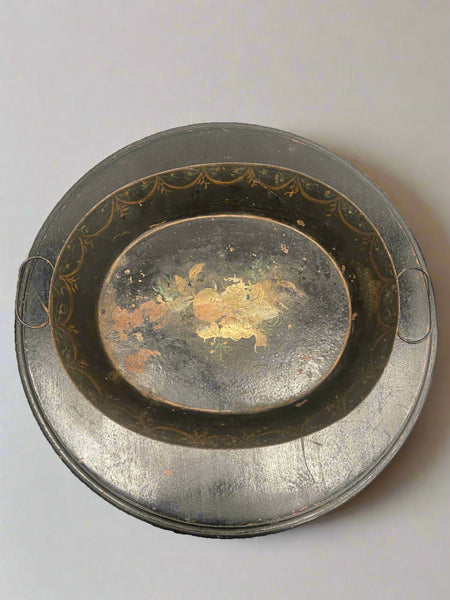 Decorative metal tray that could be used as a fruit bowl or for decorative purposes.