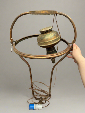 Antique hanging brass oil lamp, possibly used on a ship.