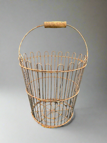A set of metal farmhouse baskets in an aged condition. Typically used for carrying eggs or other produce.