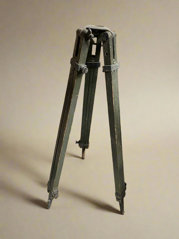 Large vintage wooden tripod in an aged condition.