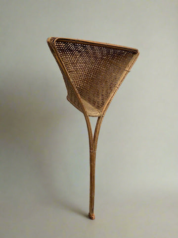 A pair of Jakhoi fishing baskets. The Jakhoi is an ingenious adaptation for a fishing trap developed by the locals. It is more like a wickerwork shovel made of bamboo and used to catch small fish, either by dragging it along or placing it on water. Jakhoi is made from a species of bamboo called the Jati.