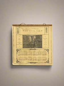 The Royal Oak brewery calendar, dated 1899. Drilled onto a wooden plank with a rope handle.