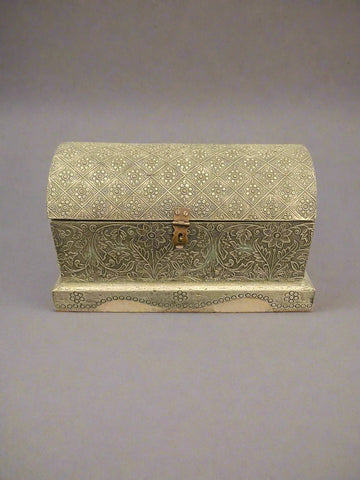 Small silver storage box with floral patterns on the body and domed top.