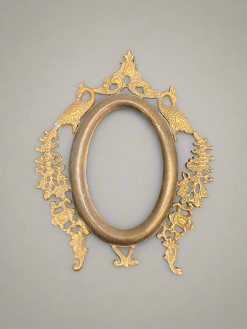 Small gold Victorian frame featuring an ornate peacock design.