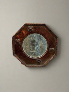 Arts & Crafts antique octagonal mirror with carved detailing.