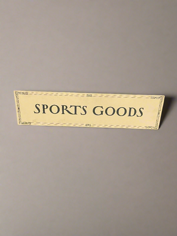 A long rectangular 'Sports Goods' sign with a decorative border.