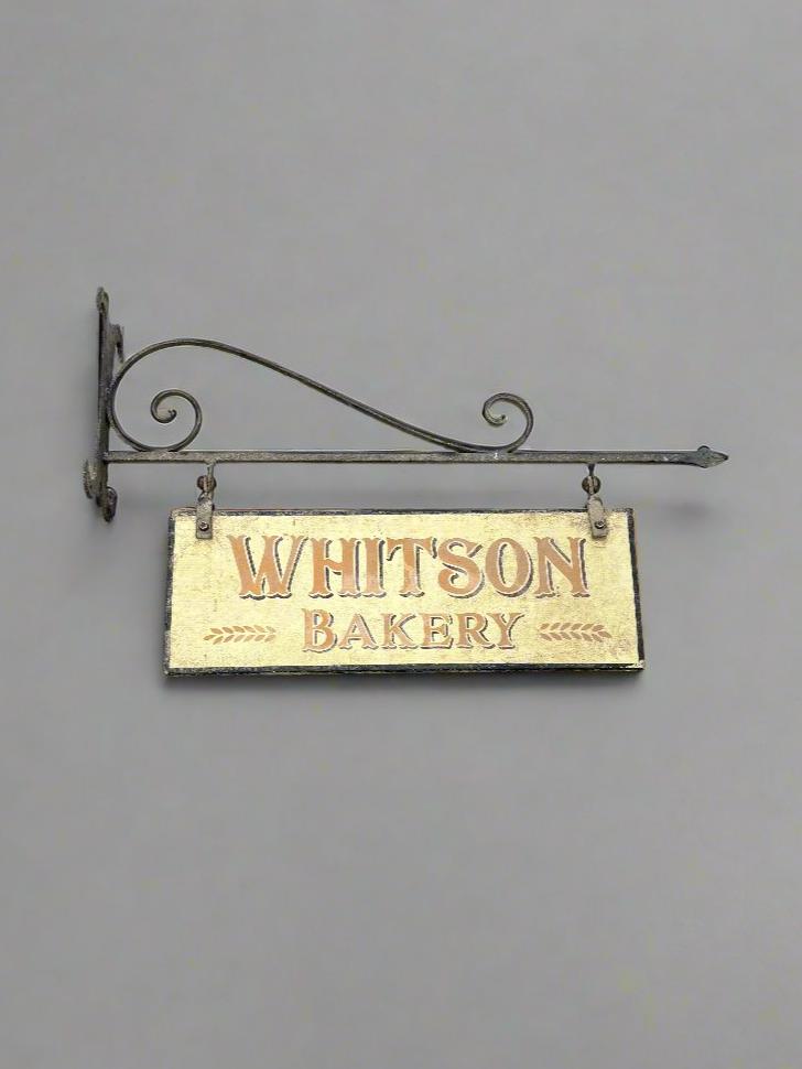 Whitson Bakery hand painted shop sign, hanging on a traditional wrought iron bracket.