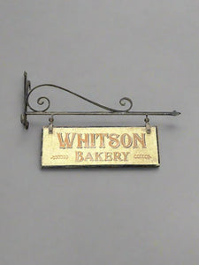 Whitson Bakery hand painted shop sign, hanging on a traditional wrought iron bracket.