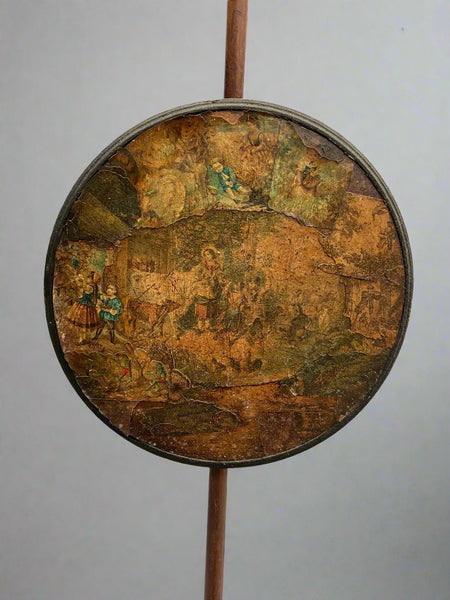 Antique fireside pole screen with decoupage decoration.