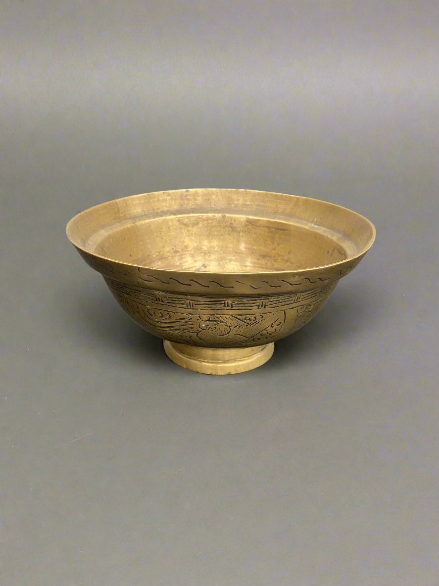 Small Chinese brass bowl with decorative engravings.