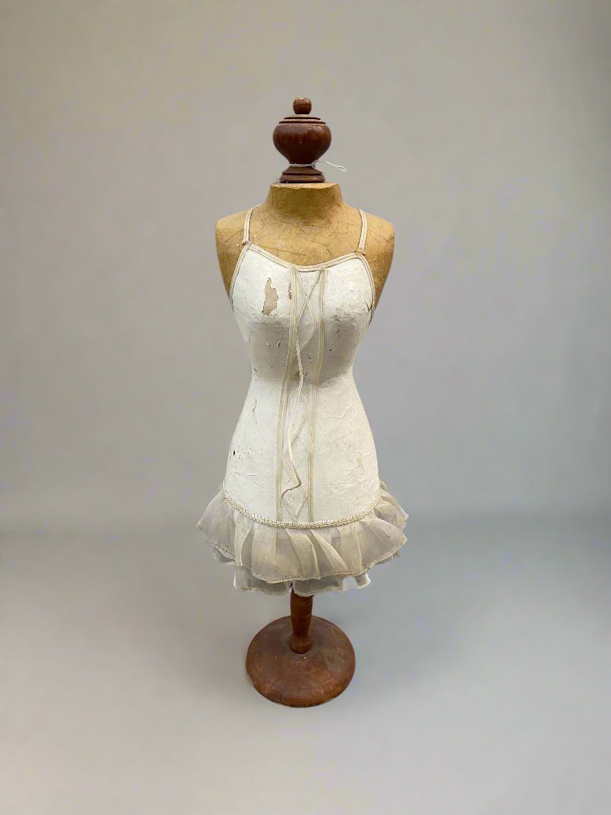 Small dress mannequin statue in an aged condition.