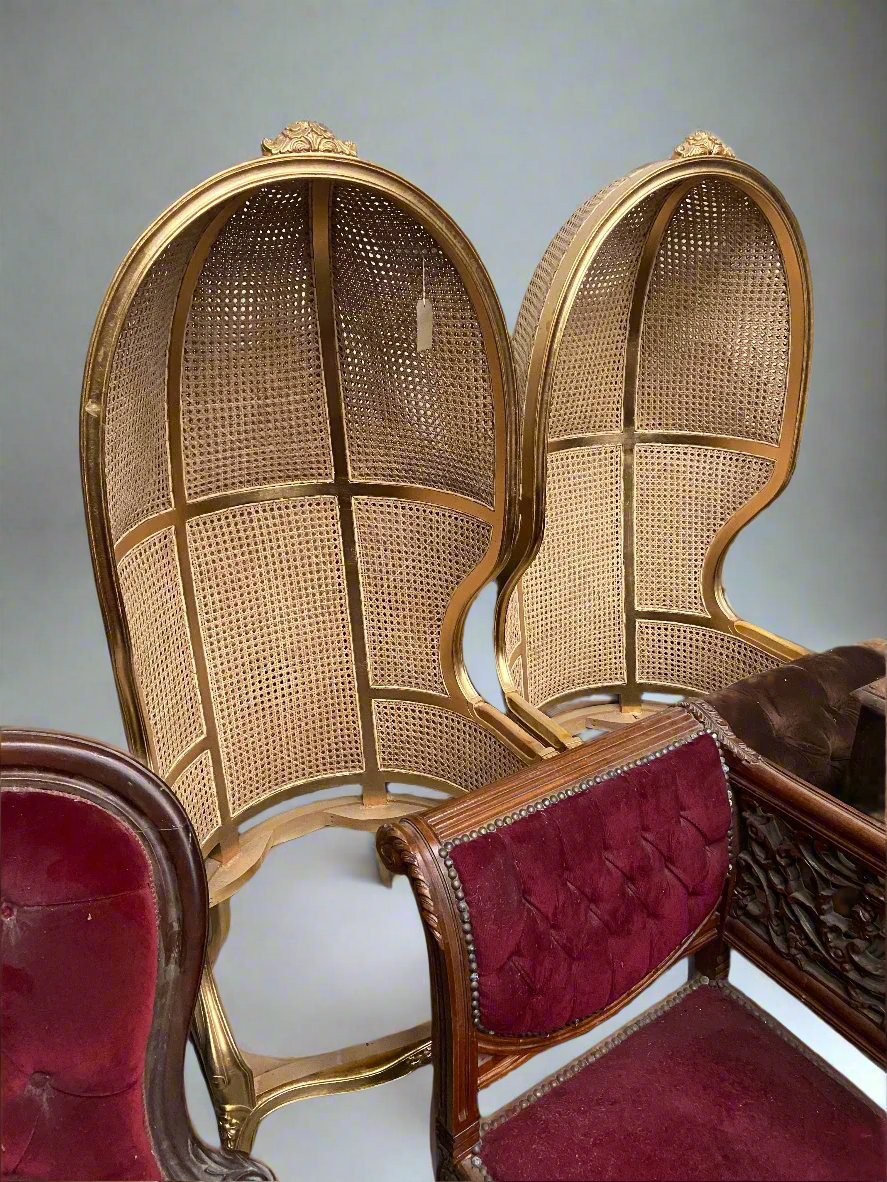 A pair of gold French cane-backed and giltwood porters chairs.