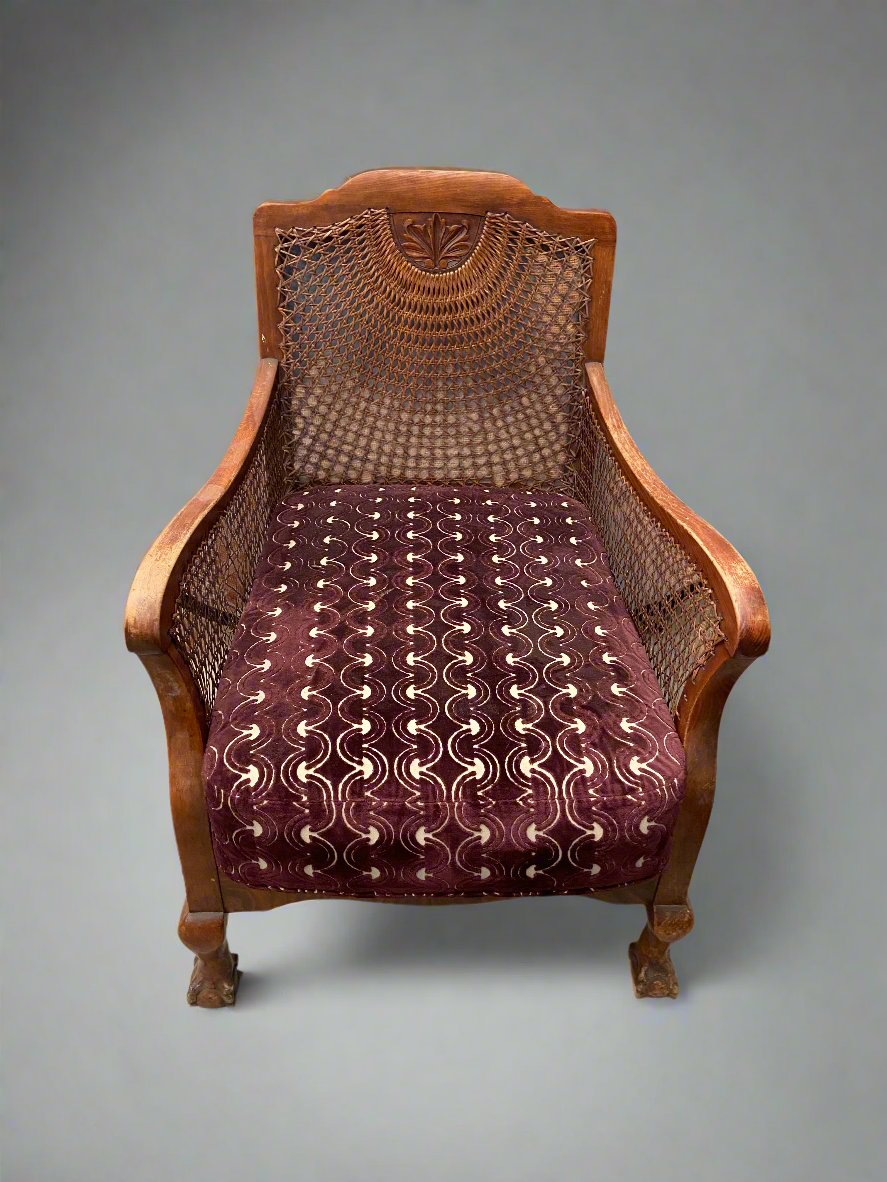 Colonial cane Bergere chair with burgundy velvet upholstery.