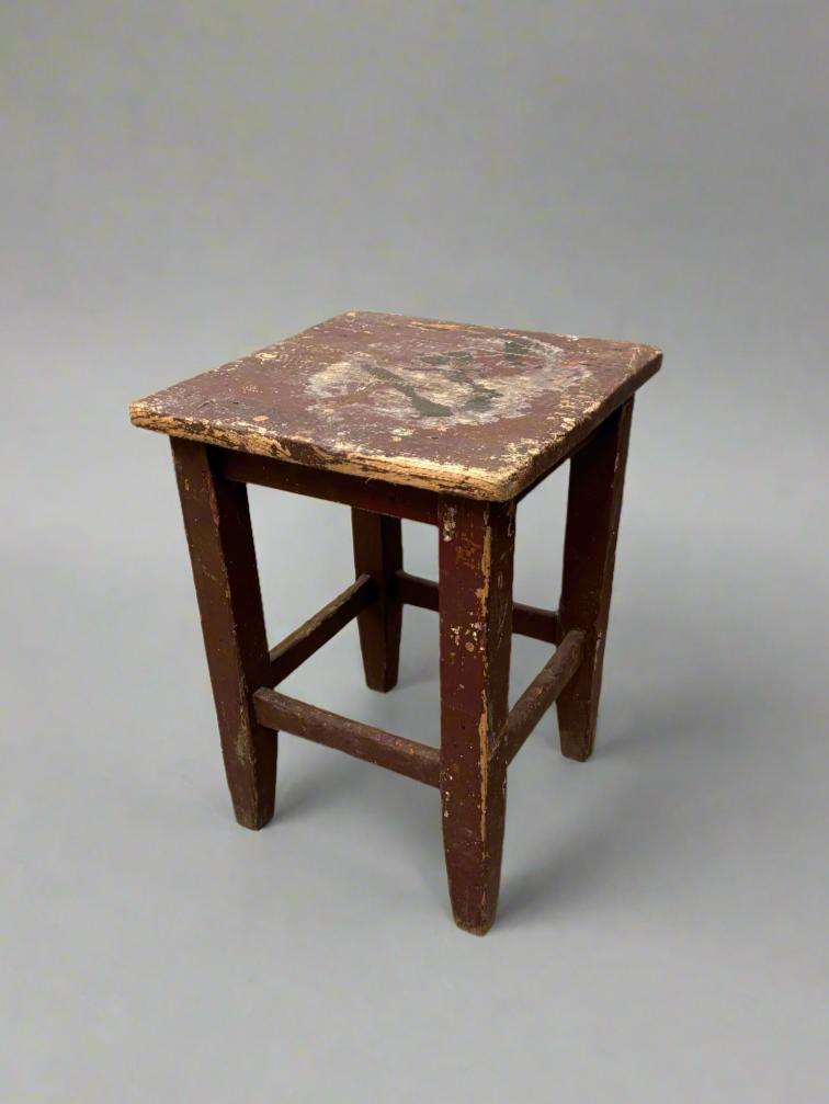 Antique school lab utility stool with an aged painted finish.