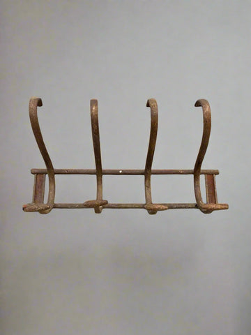 Antique Bentwood wall mounted coat rack with four hooks.