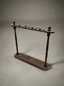 A pair of simple mahogany stick and umbrella hallway stands.