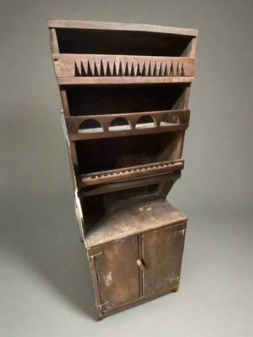 Rustic dark wood kitchen dresser with unusual hand carved detailing.