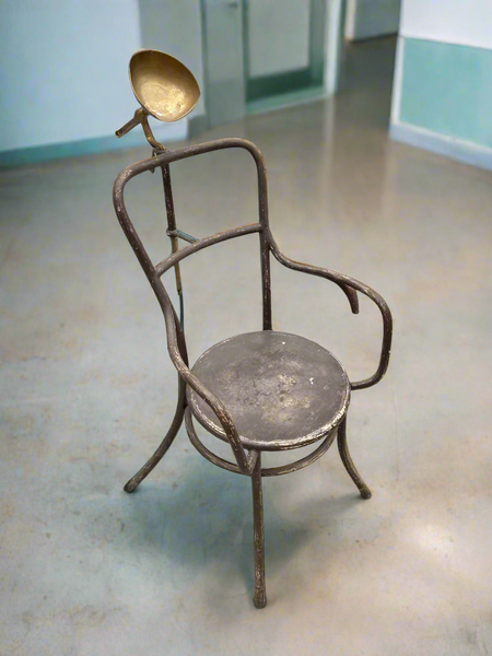 Tubular metal post mortem armchair with a metal headrest, circa 1935-1945.