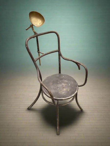 Tubular metal post mortem armchair with a metal headrest, circa 1935-1945.