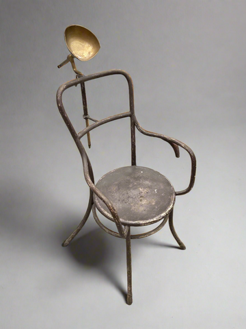 Tubular metal post mortem armchair with a metal headrest, circa 1935-1945.