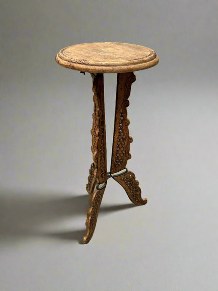 A matching pair of heavily carved tripod Indian tables/ plant stands/ jardinieres.