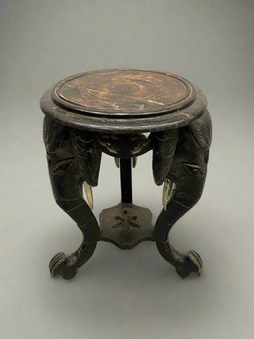 Carved ebonised pedestal table featuring Indian elephant heads.