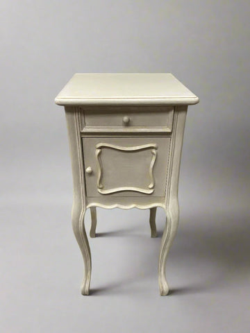 A matching pair of elegant, French, cream-painted, bedside tables with a single drawer and cupboard.